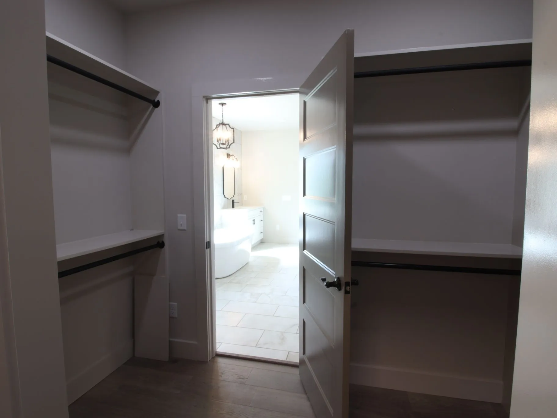 Completed JC T1 walk-in storage with built-in shelves and dark hanging rails