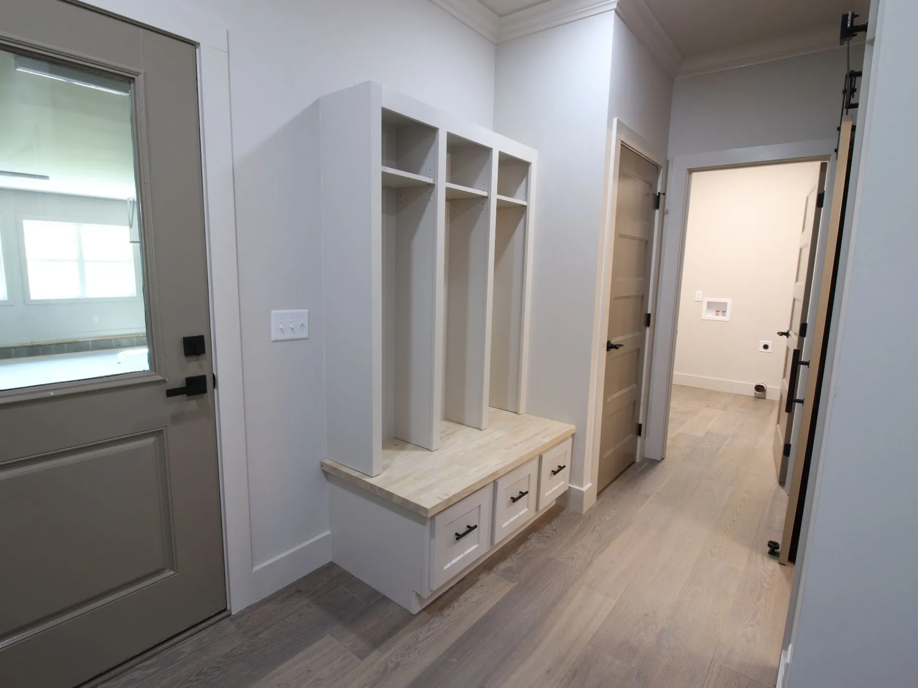 Completed JC T1 built-in cabinet and drawer storage beside a finished hallway