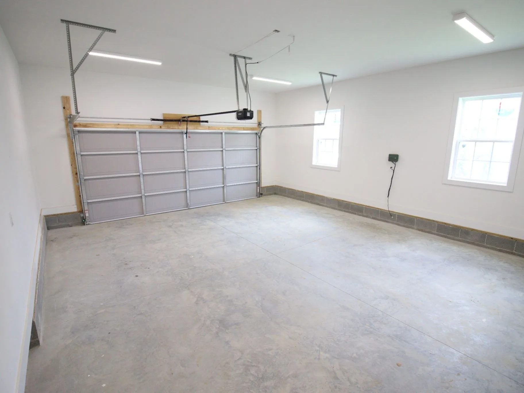 Completed JP2 New Construction garage with a finished concrete floor and open space
