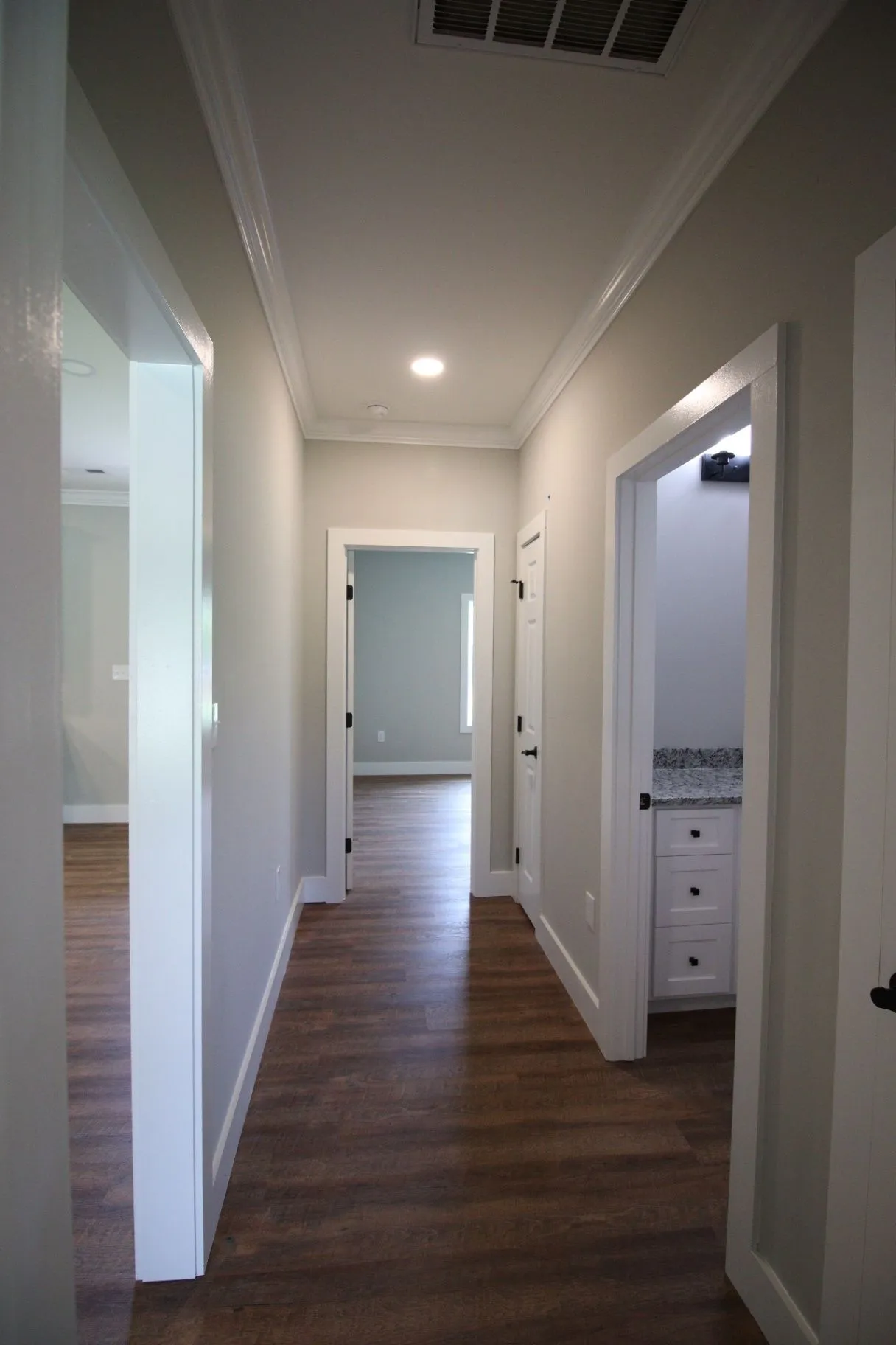 Completed JP2 New Construction hallway with wood-look flooring and finished trim